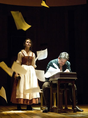 Shag at his writing desk, Judith standing behind him, and leafs of paper floating down from the rafters